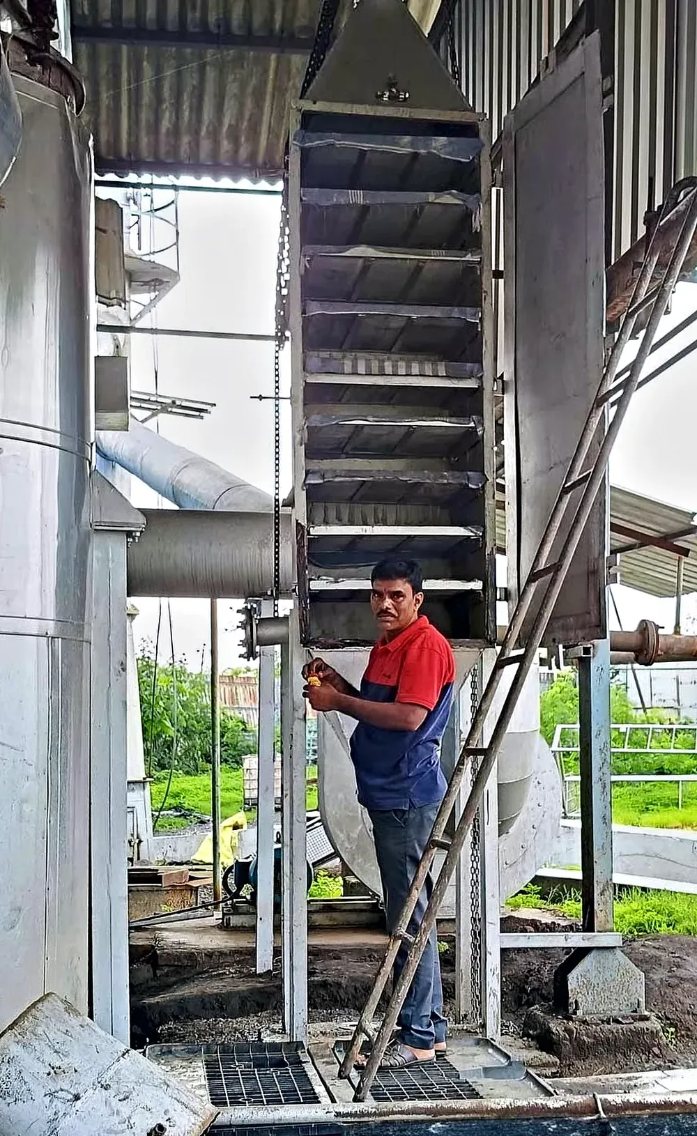 A technician beside the adsorbent trays of the Pureva tower at Romit Resins